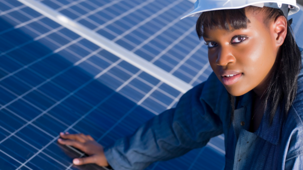 Woman technician with hand on solar photovoltaic panels.