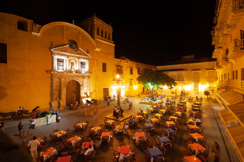 Cartagena, Colombia in the night with public lighting, a churnch and a restaurant