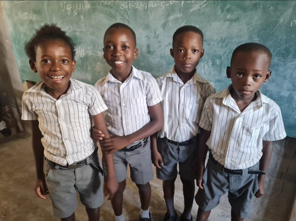 four students in a classroom in Haiti
